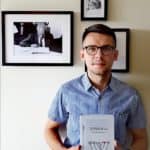 Lukasz Rzepka holds the Polish translation of my father Ben Zion Wacholder's Memories: Wspomnienia. My father's picture is hanging in the background.