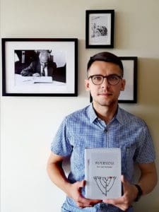 Lukasz Rzepka holds the Polish translation of my father Ben Zion Wacholder's Memories: Wspomnienia. My father's picture is hanging in the background.