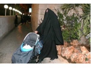 Jewish women with veil pushes stroller