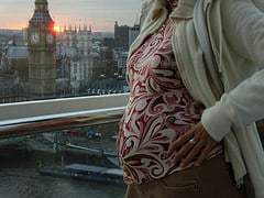 pregnant belly with background of clock tower