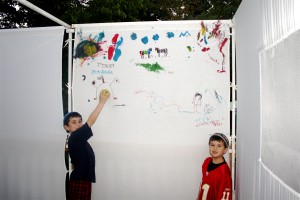 Children paint walls of their Sukkah